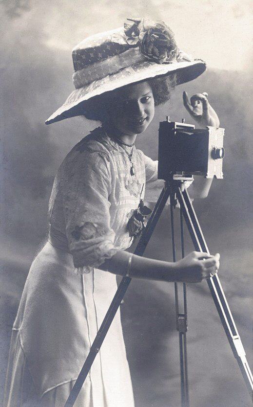 Lady with hat behind camera.