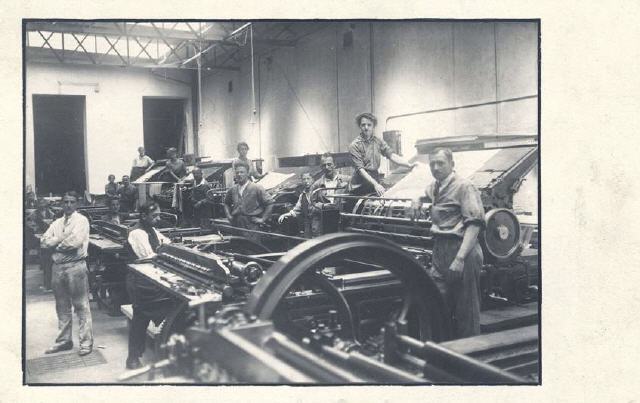 A row of Printing Presses with Staff.